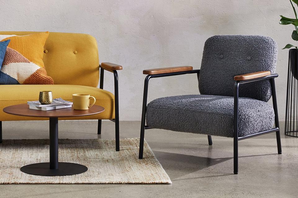 Image of mustard sofa and grey armchair.