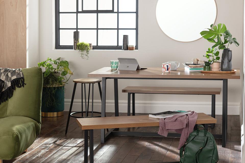 Image of scandi pale wood dining table with bench seating.