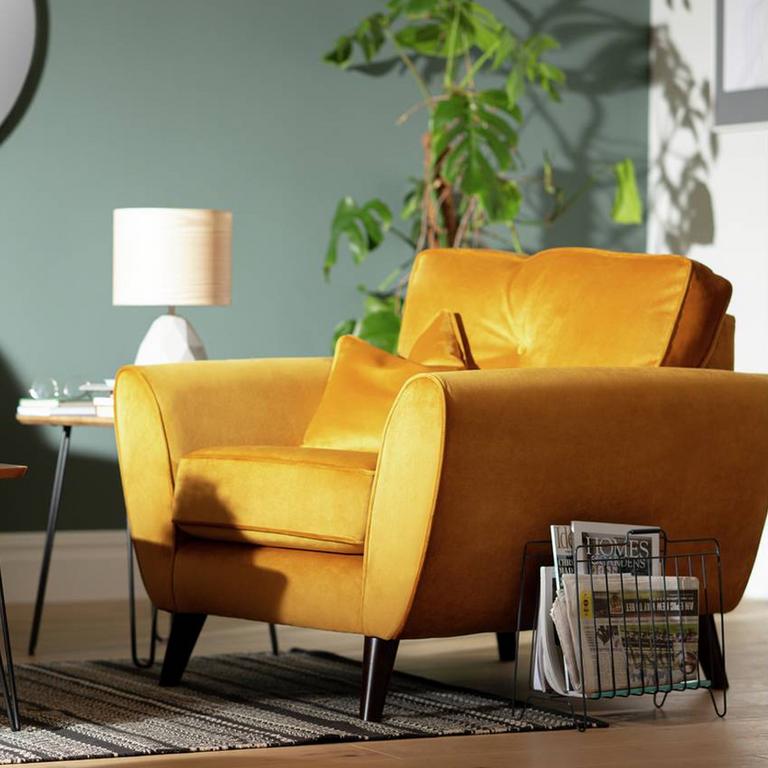 Image of a gold armchair in a living room.