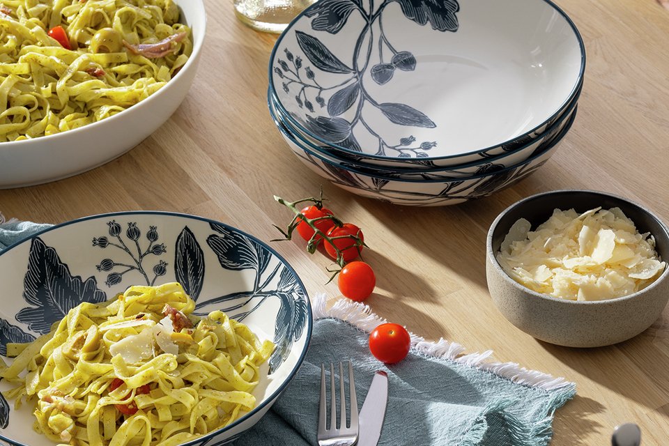 Pasta in two Habitat navy floral pasta bowls on a dining table.