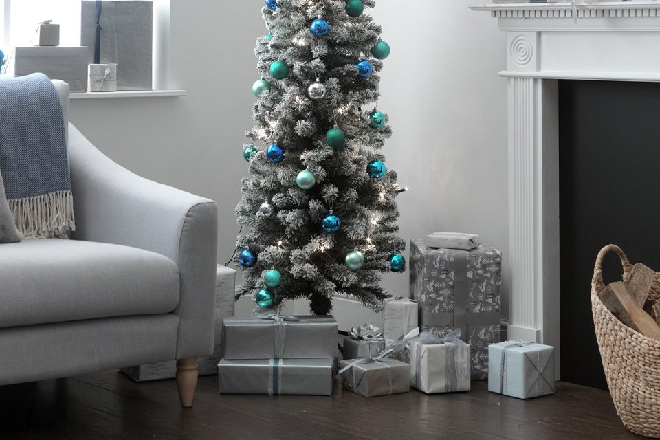 Gift boxes placed under Habitat 6ft Snow Tipped Pencil Christmas Tree.