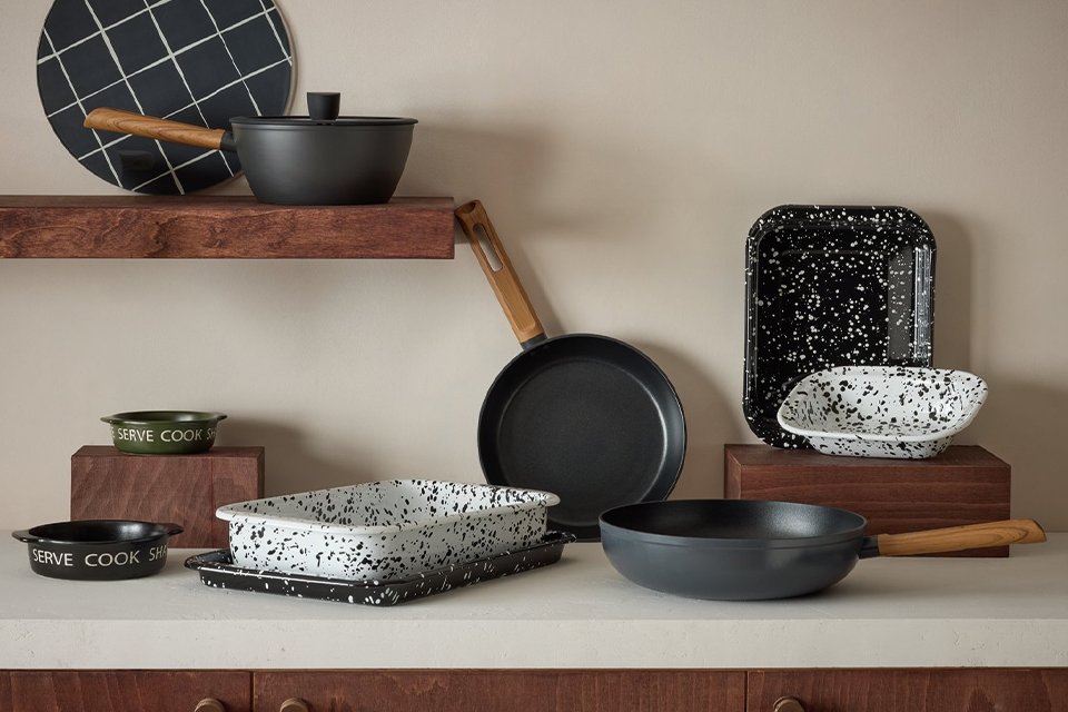 A collection of Habitat Enamel Roaster in various sizes and shapes placed on a kitchen counter.