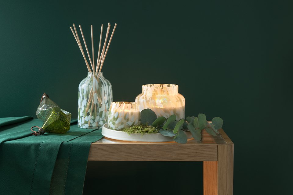 A green diffuser set on a table.
