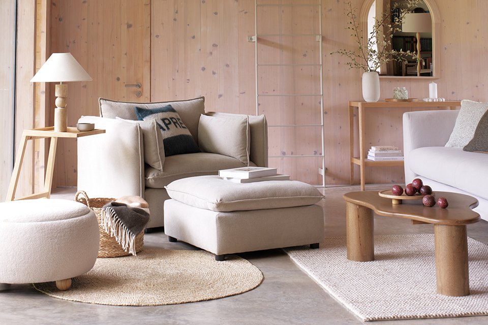 Wooden room with cream neutral furniture and cosy accessories creating a winter wonderland.