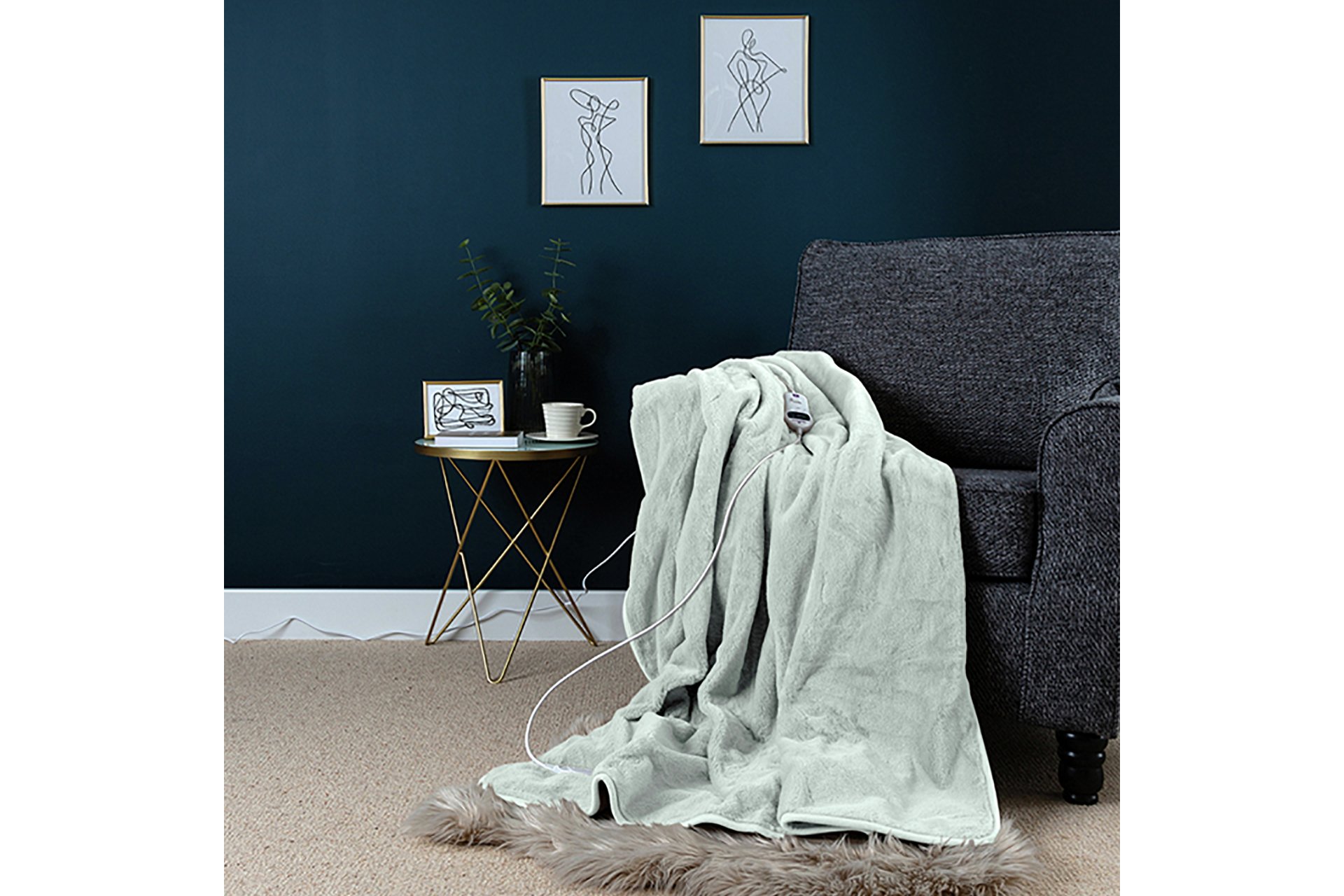Slumberdown Elegantly Warm luxury heated throw in Pistachio lying on a sofa.