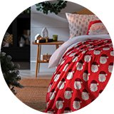 Argos Home Christmas Santa Printed Fleece Throw draped on a bed.