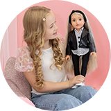 A little girl holding a 46 cm DesignaFriend Connie fashion designer doll.