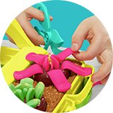 Two little hands playing with Play-Doh blooming flowers with 5 tubs and 15 accessories set.