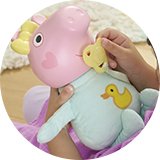 A girl playing with a Peppa pig oinks and snuggles Evie toy.