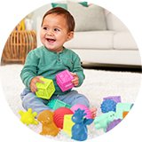 A baby playing with sensory shapes from Infantino Playtime activity toy set.