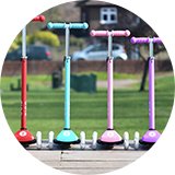 Four Zinc T-Motion Light Up kids scooters parked in a line.