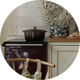 A Habitat 4 Litre Shallow Cast Iron Casserole Dish in chocolate colour placed in a kitchen decorated for Christmas.