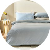 A bed made with a blue Habitat cotton single bedding set.