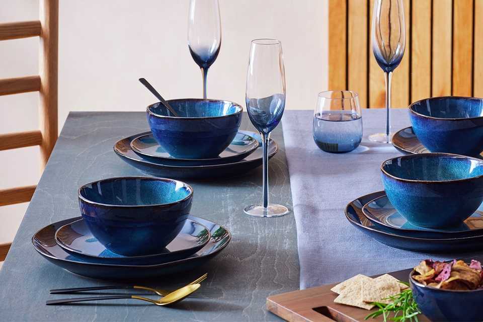 Navy reactive 12pc tableware set on a dining room table.