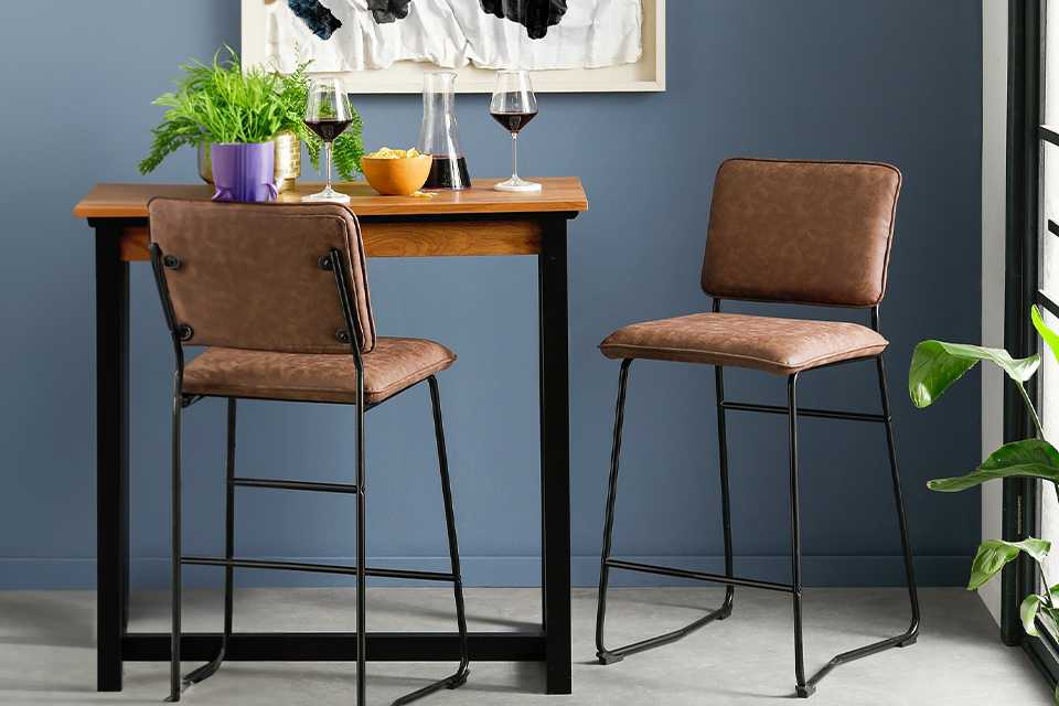 Brown faux leather bar stool with black metal legs.