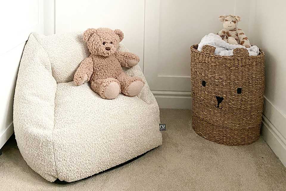 Snuggle bean chair in oat fabric with a teddy bear.