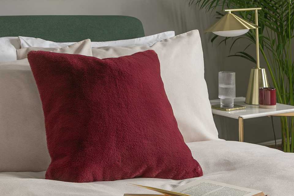 Burgundy faux fur textured velvet cushion.