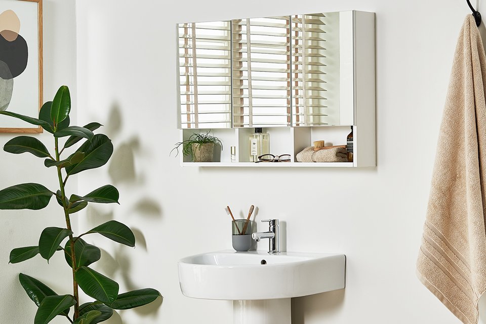 Argos Home 3 door mirrored wall cabinet in white over a white sink.