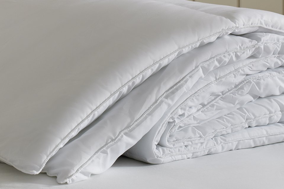 Close-up view of the Habitat Supersoft 15 Tog Double Duvet, showcasing its plush polyester filling and smooth stitched surface for a luxurious, cosy feel.
