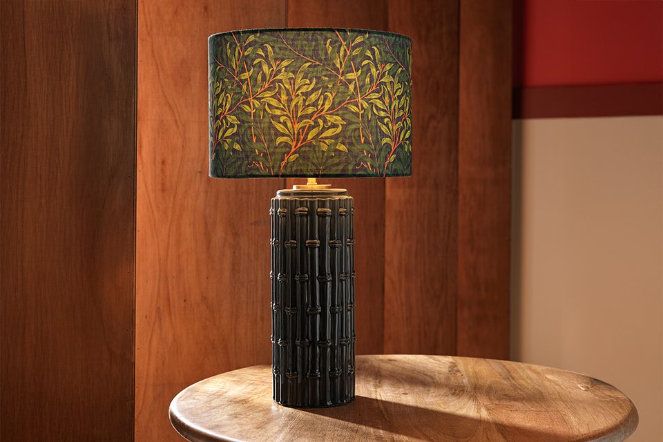 Blackthorne table lamp with embossed base and flroal shade in navy.