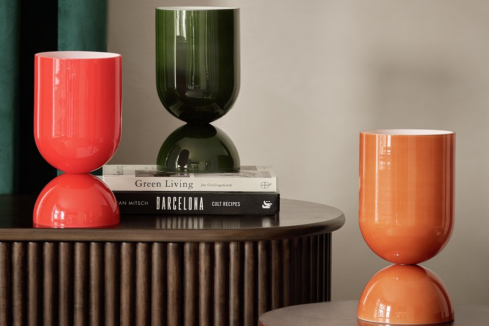 The Habitat Gloss Glass Table Lamp in green, orange and yellow.