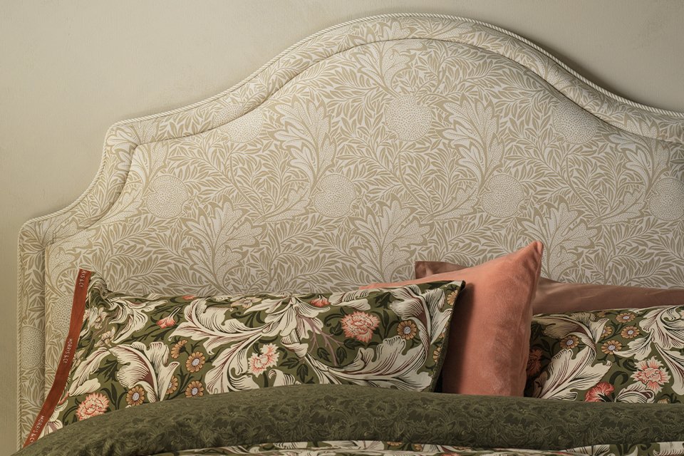 Morris and co habitat floral bedding and cushions on floral headboard.