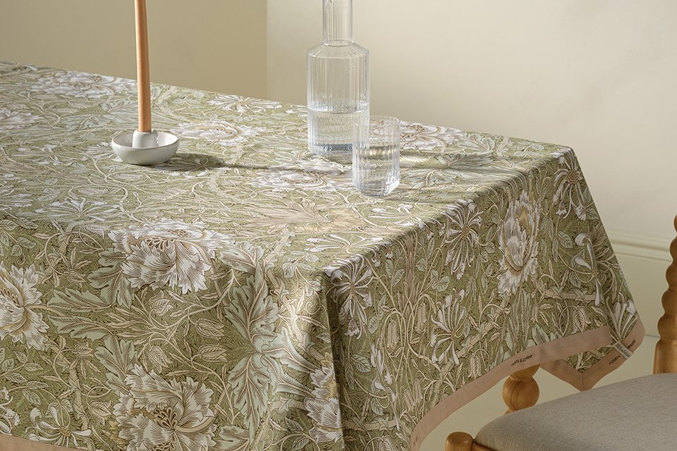 Blue dining room with morris tablware in blue chine floral print and blue tablecloth.