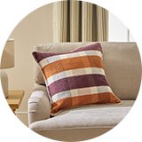 Argos Home Autumn Check Blanket Stitch Cushion on a sofa.
