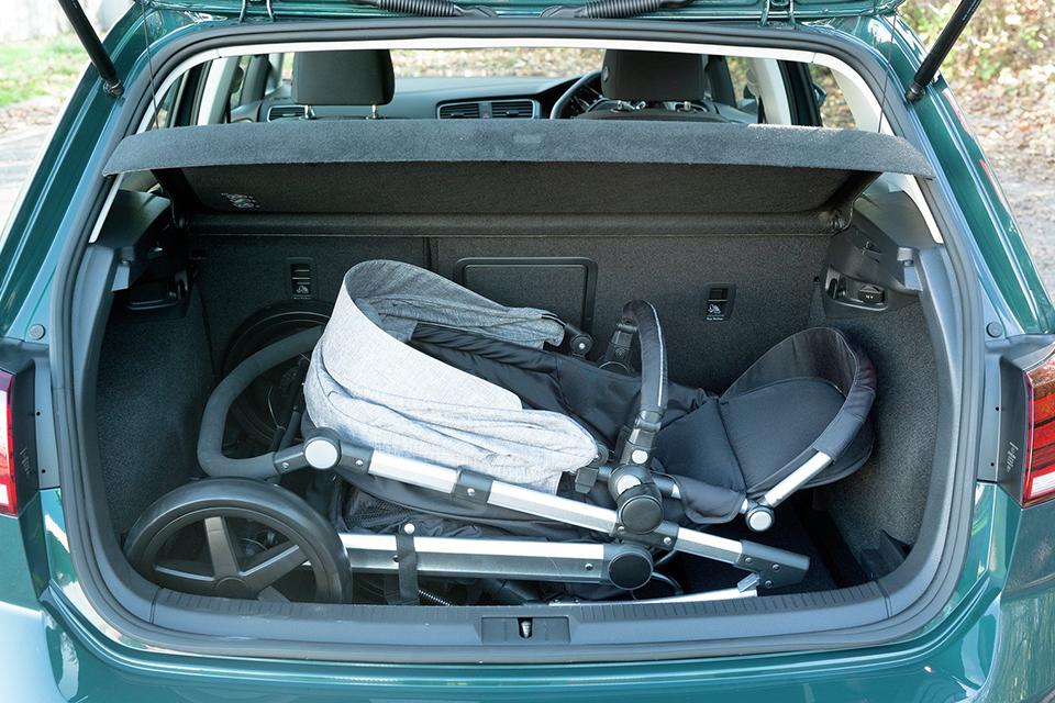 Folded up pushchair in the back of a car boot.