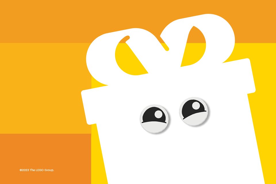 A red LEGO® logo with a gift box icon with eyes against a yellow background.