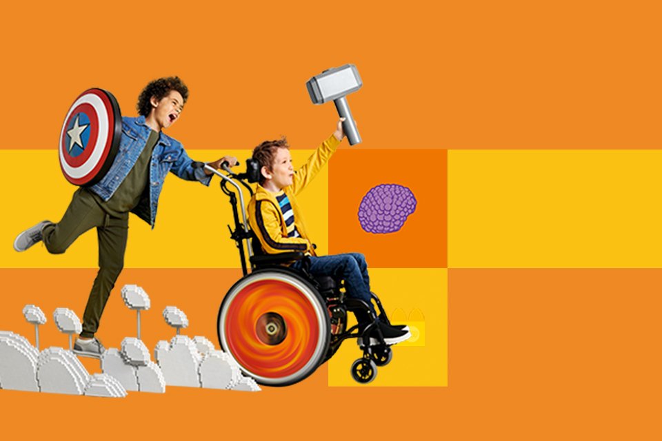 Two children pretending to be superheroes against yellow background.