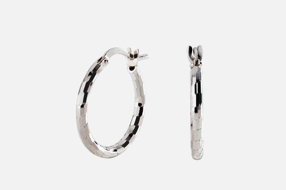 A Revere Italian silver diamond cut hoop earrings.