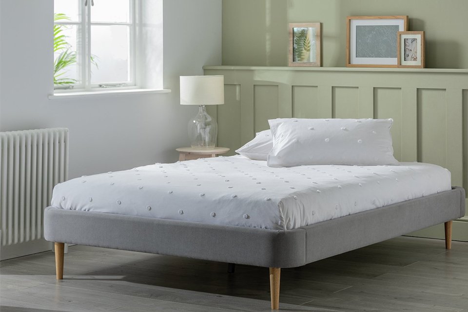 White bedroom with bed and furniture.