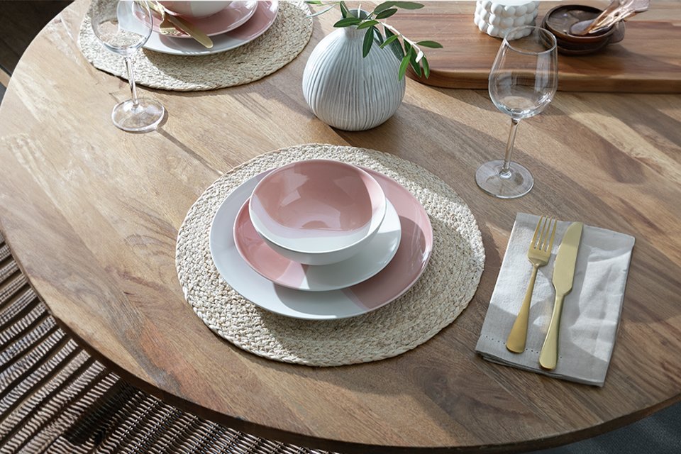 A table set with a Habitat dipped 12 piece multicoloured stoneware dinner set.