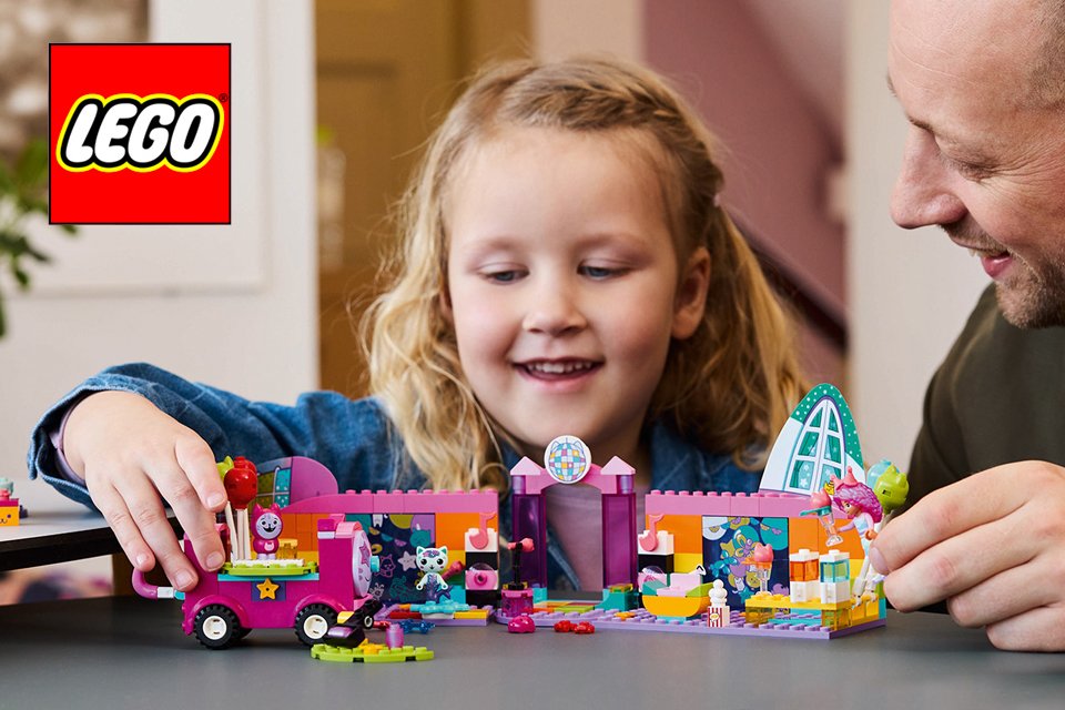 A little girl playing with Gabby's LEGO® dollhouse set.