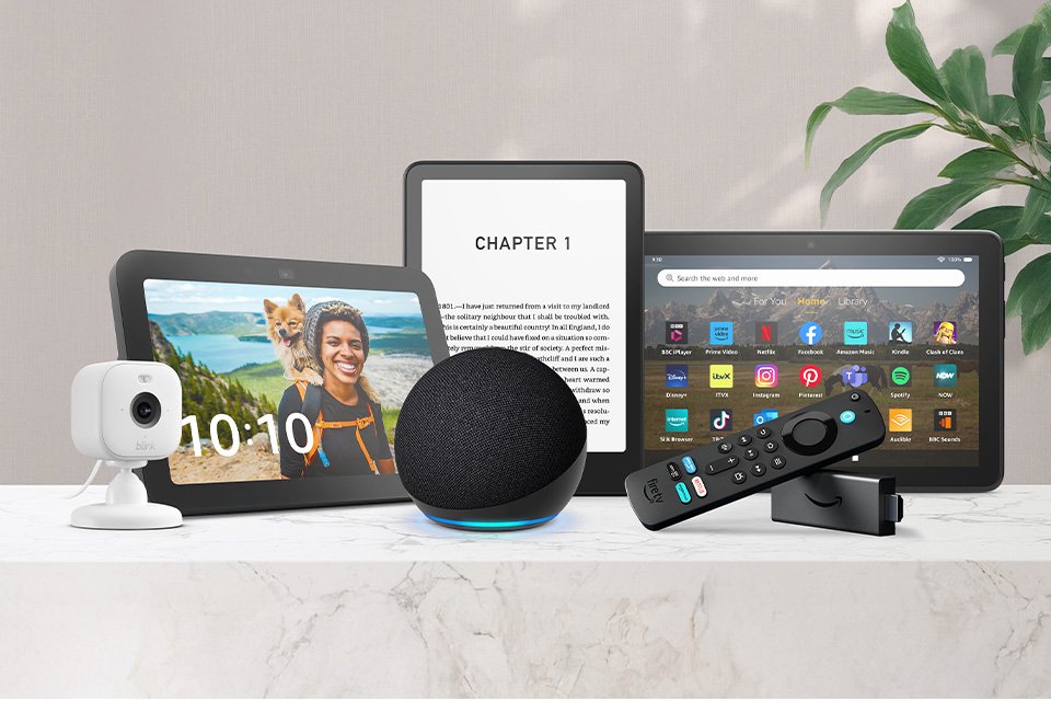 A collection of Amazon devices displayed on a white table top. 