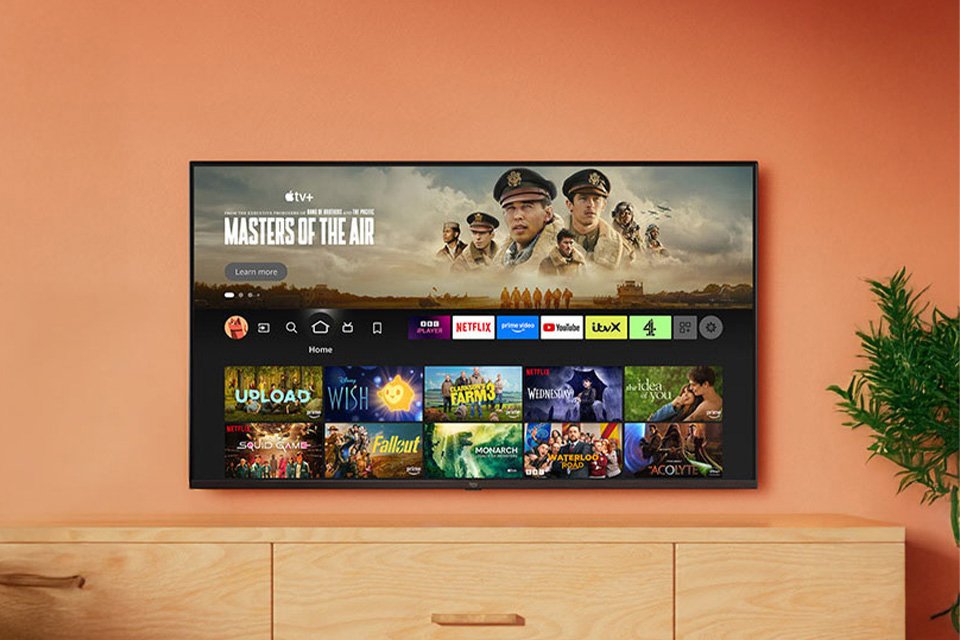 A wall mounted smart TV with built-in Alexa in a living room setup. 