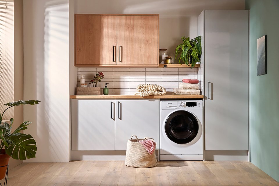 Hotpoint NDD86448WDAUK 8kg/6kg 1400 Spin Washer Dryer in white colour in a laundry room.