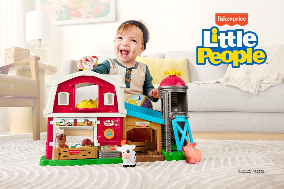A toddler playing with Fisher Price Little People toy set.