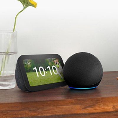 Amazon Echo Dot and Eco Show smart speakers placed on a wooden table. 
