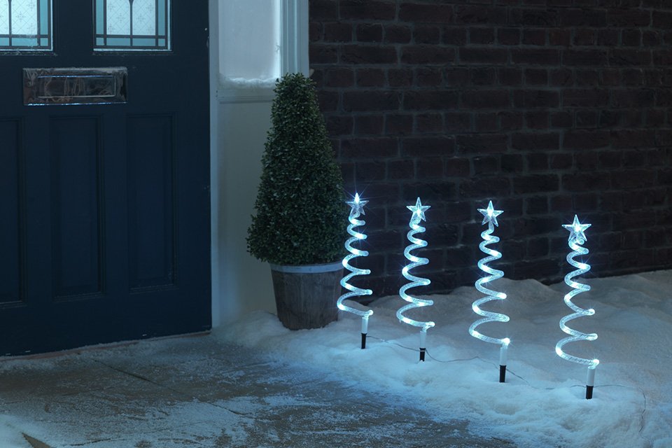 Habitat Pack of 4 Christmas Spiral Tree Path Finder Lights leading to a blue door.