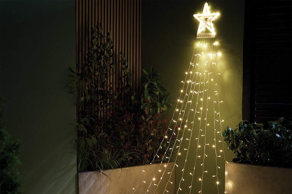 Habitat Warm White LED Light Star Waterfall Decoration in a corner.