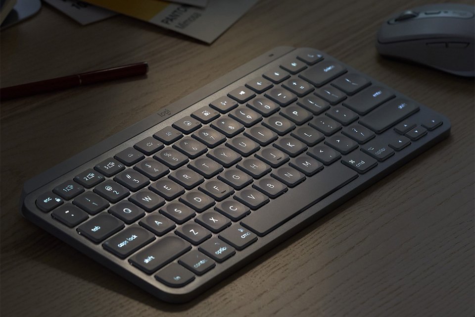 A Logitech mini wireless keyboard next to a mouse on a table.