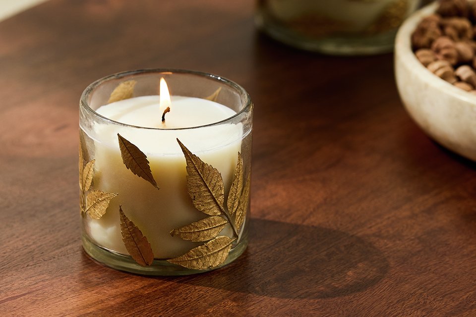 Argos Home floral pressed small glass candles on a table.