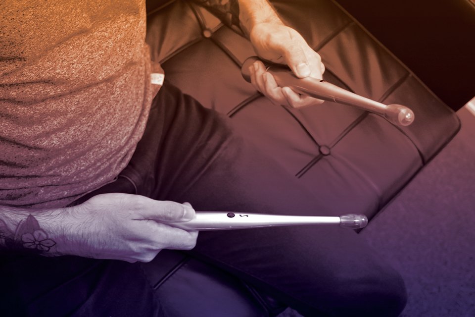 A person using digital drumsticks.