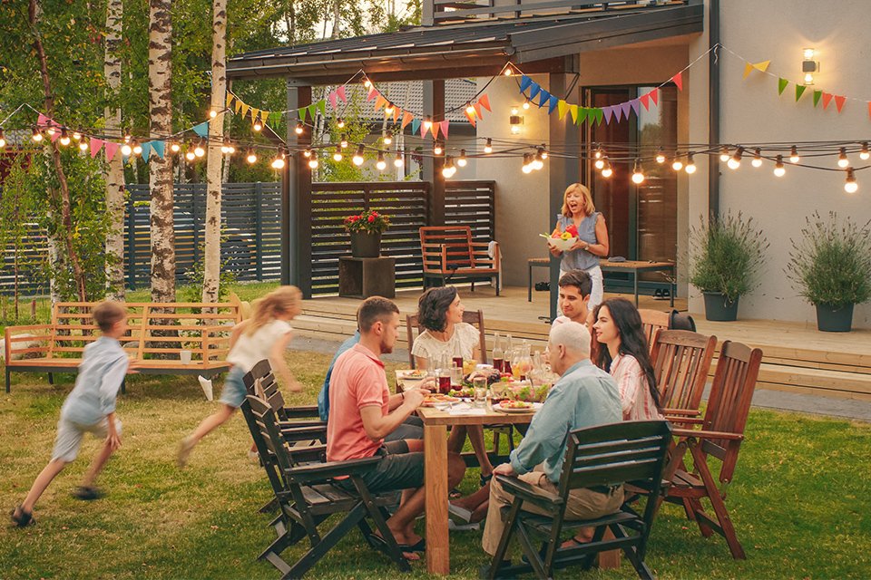 Adults and kids having an outdoor party.