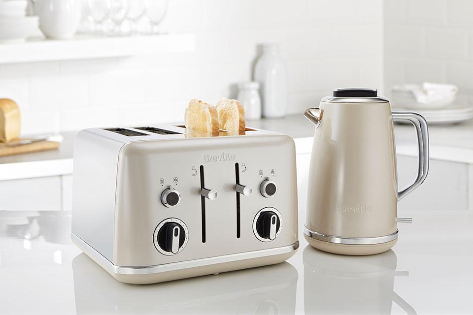 A retro looking kettle and toaster on a kitchen side.