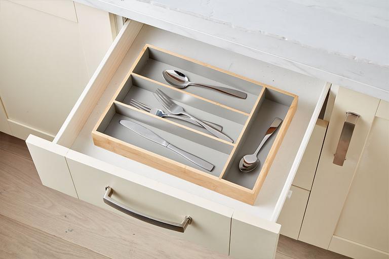 Image of an open cutlery draw with silver cutlery inside.