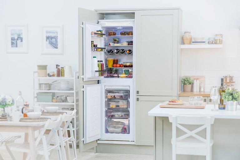Image of an open fridge in a country kitchen.