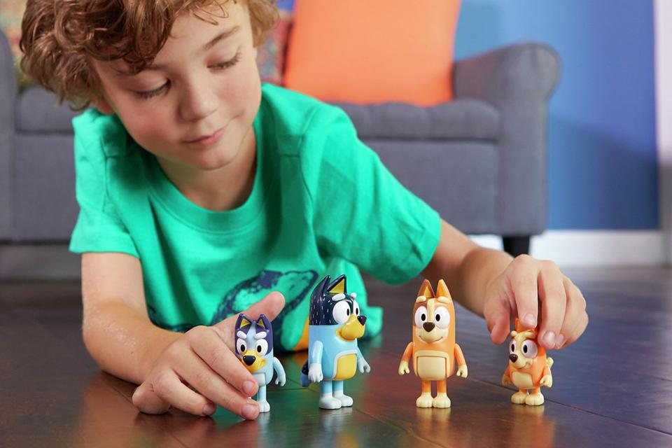 Boy playing with the Bluey Family 4 Figure Pack.
